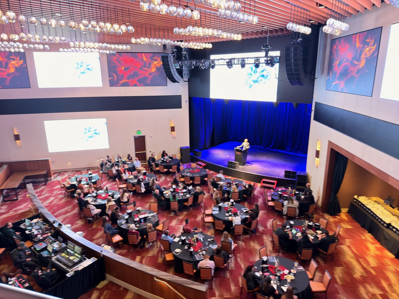 The showroom during the symposium, event films running on the screens around the walls