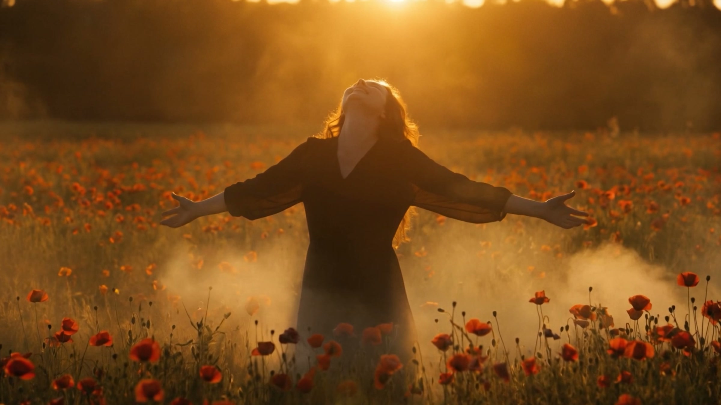 A woman standing in a golden poppy field with her arms open